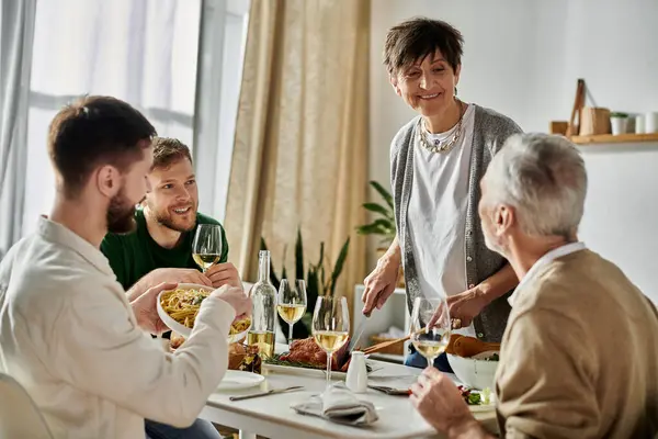 A gay couple enjoys a meal with parents at home. — Stock Photo