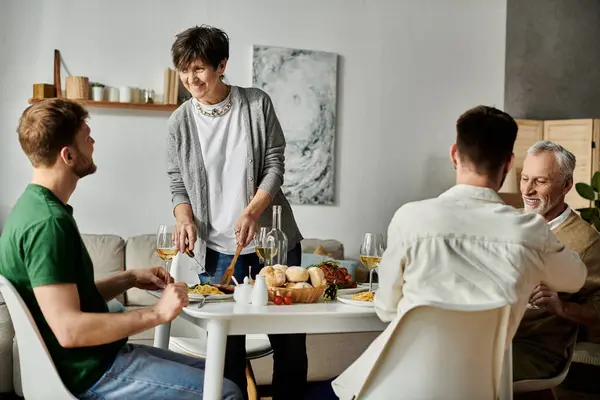 A gay couple enjoys a meal with their family at home. — Stock Photo