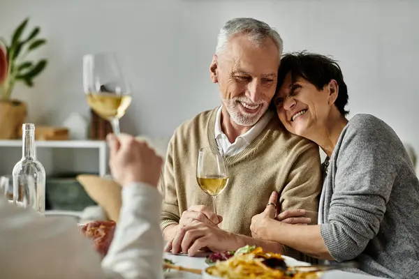 Parents share meal with their son and his partner at a cozy dinner at home. — Stock Photo