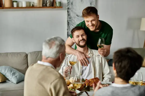 A gay couple introduces their partner to their family at a home dinner. — Stock Photo