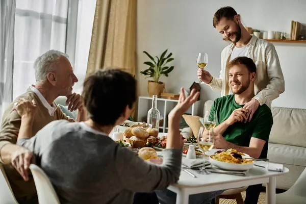 A gay couple enjoys a meal with parents at home, raising a toast to love and acceptance. — Stock Photo