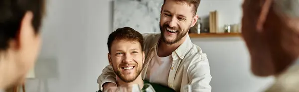 A gay couple smiles and laughs while meeting parents at home. — Stock Photo