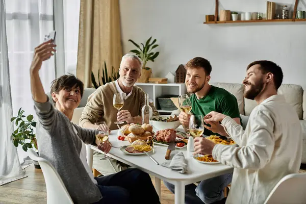 A gay couple shares a meal with parents. — Stock Photo