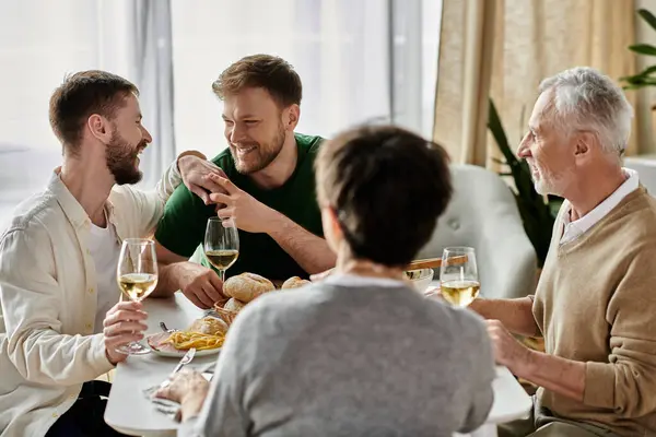 A gay couple enjoys a meal with parents at home. — Stock Photo