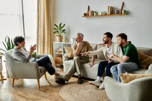 A gay couple sits with parents in a living room, engaged in conversation. — Stock Photo
