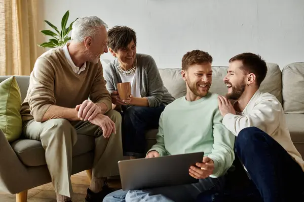 A gay couple shares a moment with parents in their home, filled with laughter and warmth. — Stock Photo