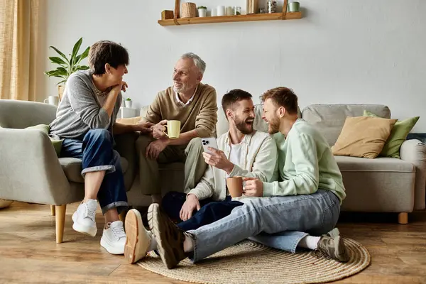A gay couple introduces their partners to parents in a living room setting. — Stock Photo