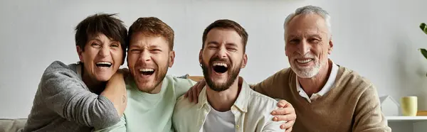 A gay couple shares a joyous laugh with parents, creating a heartwarming scene of family love and acceptance. — Stock Photo