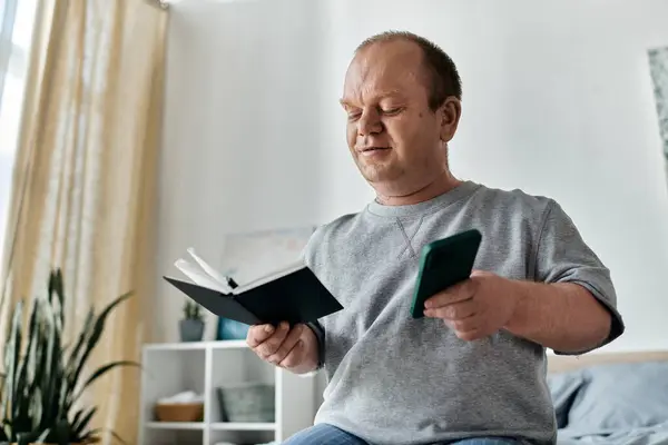 A man with inclusivity immersed in reading while seated on a cozy couch. — Stock Photo