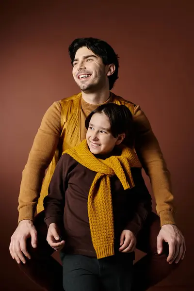 A father and son smile at each other, showcasing a heartwarming moment of shared happiness. — Stock Photo