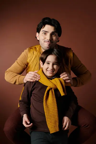 A father and son pose for a portrait with playful expressions. — Stock Photo
