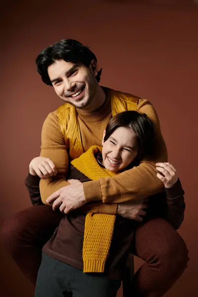 A father and son share a warm embrace, laughing together. — Stock Photo