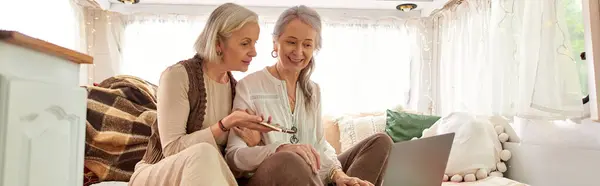 A lesbian couple enjoys a moment of togetherness while on a road trip in their camper van. — Stock Photo