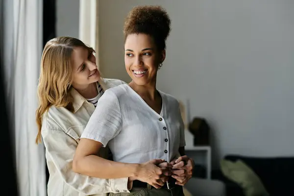A lesbian couple embraces in a loving moment at home. — Stock Photo