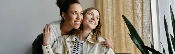 Two women, a diverse lesbian couple, enjoy a cozy moment together in their home. — Stock Photo