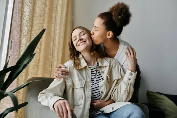 A diverse lesbian couple shares a tender moment at home. — Stock Photo