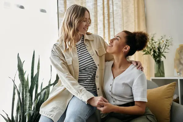 A lesbian couple, dressed casually, shares a loving moment at home. — Stock Photo