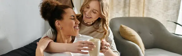 A lesbian couple shares a tender moment at home, showcasing their love and connection. — Stock Photo