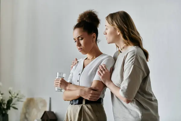 Two women, a lesbian couple, embrace in a moment of comfort at home. — Stock Photo