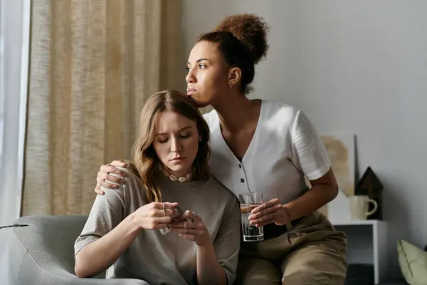 A diverse lesbian couple embraces each other in their home, showing affection and support in a tender moment. — Stock Photo
