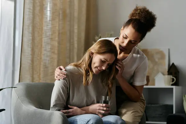A lesbian couple finds solace in each others presence at home. — Stock Photo