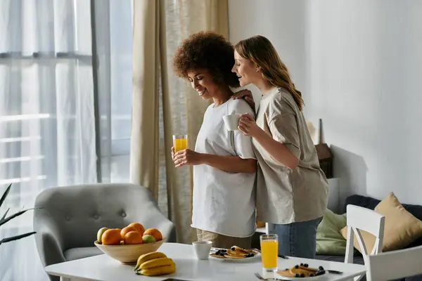 Two women in casual attire enjoy a morning together in their home. — Stock Photo