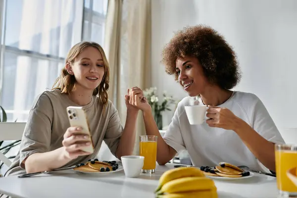 A lesbian couple enjoys coffee and pancakes at home. — Stock Photo