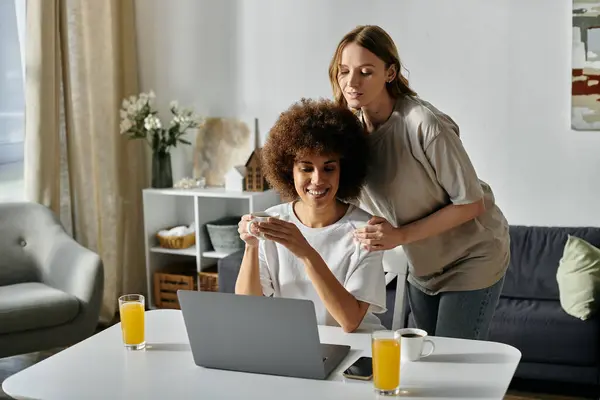 A lesbian couple shares a tender moment at home. — Stock Photo