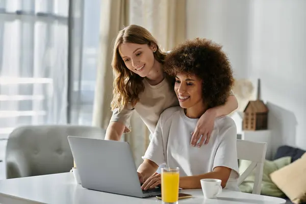 A diverse lesbian couple relaxes at home, enjoying a morning together. — Stock Photo