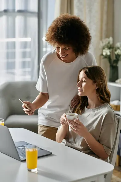 A lesbian couple enjoys a cozy morning at home, sharing a laugh and a moment of togetherness. — Stock Photo