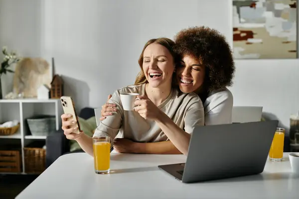 A lesbian couple enjoys a morning together at home. — Stock Photo