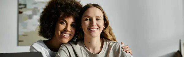 Two women, in casual attire, pose for a picture at home, smiling and embracing. — Stock Photo