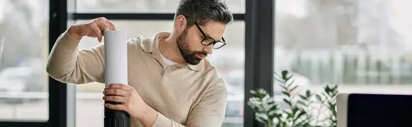 Un homme d'affaires barbu travaille sur un projet dans son bureau moderne. — Photo de stock