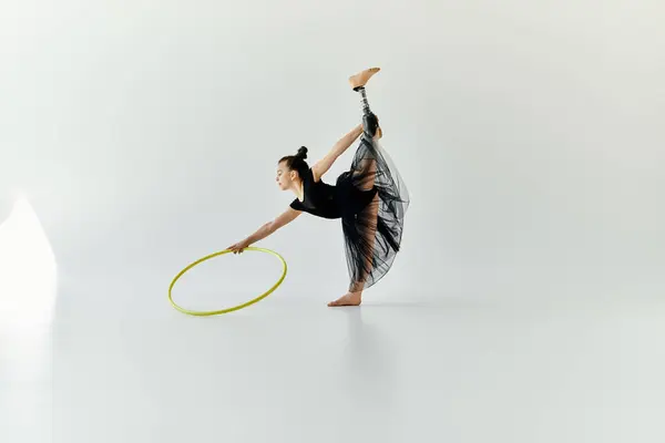 A young girl with a prosthetic leg performs a graceful gymnastic pose with a hoop. — Stock Photo
