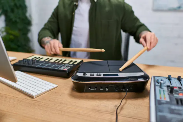 A handsome Asian man plays a drum pad in a studio setting. — Stock Photo