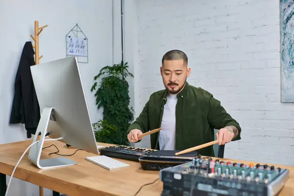 An Asian man plays drums in a studio setting. — Stock Photo