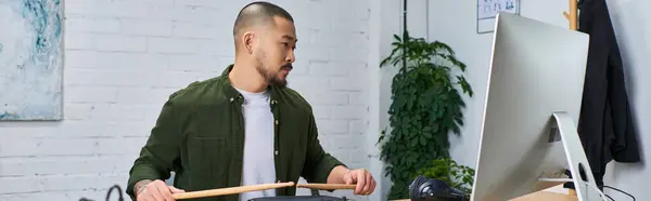 A handsome Asian man plays drums in a studio setting. — Stock Photo
