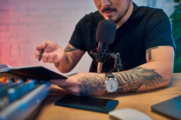 A handsome Asian man recording a podcast in his home studio. — Stock Photo