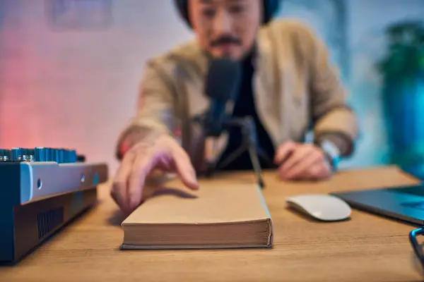 A close-up shot of a book on a desk in a podcast studio. — Stock Photo