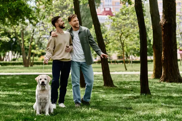 A bearded gay couple enjoys a leisurely walk with their Labrador Retriever in a green park. — Stock Photo