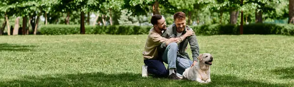 Two bearded men, a gay couple, are enjoying a sunny day in the park with their labrador retriever. — Stock Photo