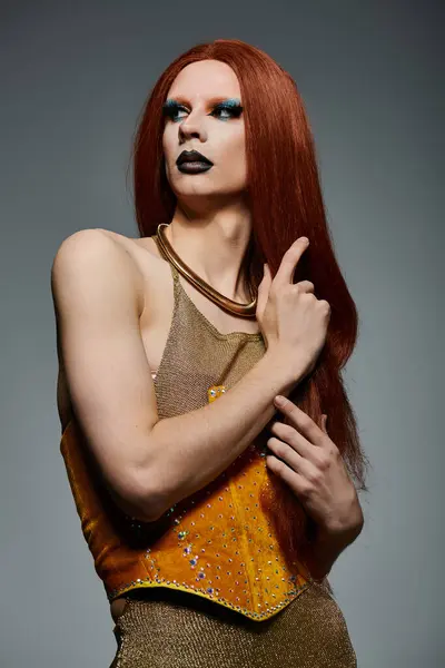 A drag queen in a golden corset and mesh top poses for a photoshoot. — Stock Photo
