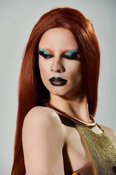 A drag queen with long red hair and bold makeup looks confidently into the camera. — Stock Photo