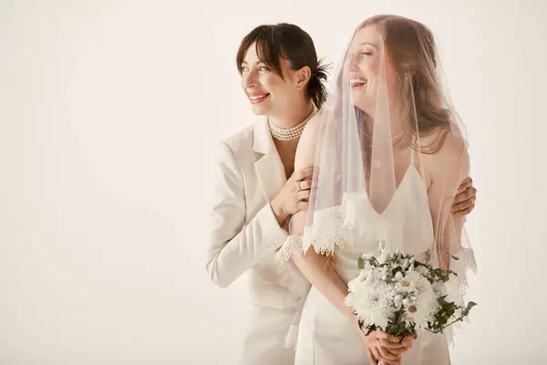 Two brides in white attire embrace on their wedding day, sharing a tender moment of joy and love. — Stock Photo