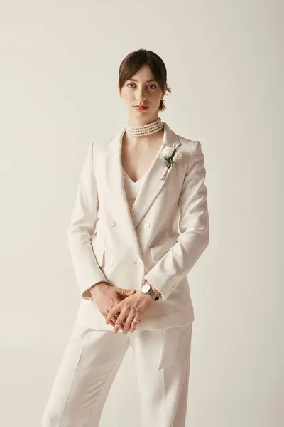 Una hermosa novia joven posa en un vestido de novia blanco clásico, exudando elegancia y estilo. - foto de stock