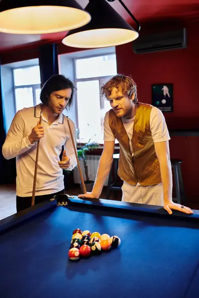 Friends casually dressed in stylish attire stand by a billiard table, seemingly taking a break from a game. — Stock Photo