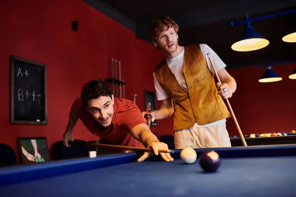 Friends play a game of pool in a casual setting, with one focused on taking a shot. — Stock Photo