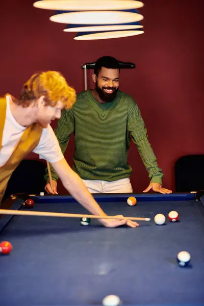 Friends enjoy a casual game of billiards in a stylish setting. — Stock Photo