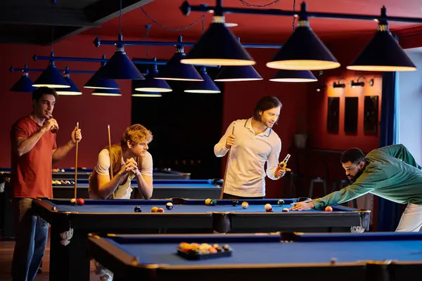 Friends play a game of billiards in a dimly lit bar. — Stock Photo