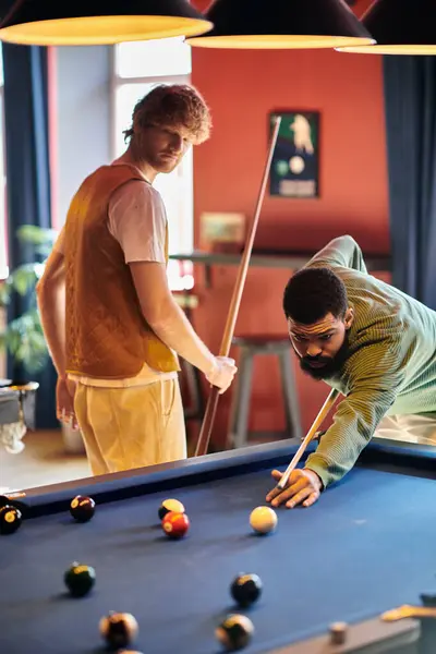 Friends play a casual game of billiards, enjoying the relaxed atmosphere. — Stock Photo